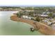 Aerial view of lakefront community amenities, including a clubhouse, pool, and pier with seating area at 10129 Sw 77Th Loop, Ocala, FL 34481