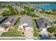 Aerial view of a well-maintained house with driveway, landscaping, and a nearby lake at 10129 Sw 77Th Loop, Ocala, FL 34481