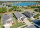 Aerial view of a well-maintained house with driveway, landscaping, and a nearby lake at 10129 Sw 77Th Loop, Ocala, FL 34481