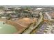 Aerial view of community amenities, including a baseball field, tennis courts, clubhouse, and lake at 10129 Sw 77Th Loop, Ocala, FL 34481