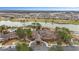 Aerial view showcasing a resort-style clubhouse, swimming pool, lake, golf course, and numerous residential homes at 10129 Sw 77Th Loop, Ocala, FL 34481