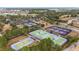 Community aerial view of the tennis and pickleball courts with surrounding foliage and homes at 10129 Sw 77Th Loop, Ocala, FL 34481