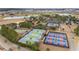 Aerial view of the community's tennis and pickleball courts in a well-maintained neighborhood at 10129 Sw 77Th Loop, Ocala, FL 34481