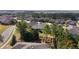 Aerial view of a well-maintained house with driveway, landscaping, and mature trees in a quiet neighborhood at 10129 Sw 77Th Loop, Ocala, FL 34481