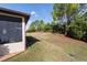 Exterior view of backyard and lawn, with landscaping and home exterior visible in the background at 10129 Sw 77Th Loop, Ocala, FL 34481