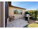 Paver patio with grill, chair, and view of the yard and lush, green landscaping at 10129 Sw 77Th Loop, Ocala, FL 34481