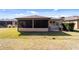 Exterior side view of the property showing patio area and the grassy backyard at 10129 Sw 77Th Loop, Ocala, FL 34481