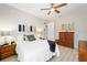 Relaxing bedroom with white bedding, soft lighting, and hardwood floors at 10129 Sw 77Th Loop, Ocala, FL 34481