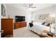 Cozy bedroom with neutral colors, ceiling fan, and wood furnishings at 10129 Sw 77Th Loop, Ocala, FL 34481