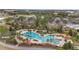 Aerial view of a sparkling blue community pool surrounded by palm trees, lounge chairs, and manicured landscaping at 10129 Sw 77Th Loop, Ocala, FL 34481