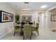Beautiful dining room with a glass table, art, and natural light from a skylight at 10129 Sw 77Th Loop, Ocala, FL 34481