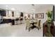Open-concept dining area featuring tile floors, modern lighting, and seamless connection to the living room at 10129 Sw 77Th Loop, Ocala, FL 34481