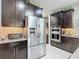 Modern kitchen with stainless steel appliances and dark cabinetry at 10129 Sw 77Th Loop, Ocala, FL 34481