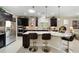 Stylish kitchen featuring a large island, dark wood cabinets, and stainless steel appliances at 10129 Sw 77Th Loop, Ocala, FL 34481