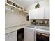 Bright laundry room features modern washer and dryer and upper cabinets at 10129 Sw 77Th Loop, Ocala, FL 34481