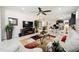 Spacious living room with open layout, a large TV, and natural light throughout at 10129 Sw 77Th Loop, Ocala, FL 34481