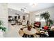 Open-concept living space with a sitting area, stone accents, and views of the kitchen at 10129 Sw 77Th Loop, Ocala, FL 34481