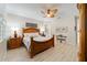 Comfortable main bedroom showcasing natural light, wood-look floors, and neutral decor at 10129 Sw 77Th Loop, Ocala, FL 34481