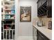 Well-organized pantry with shelving, storage, wine refrigerator, and wine rack at 10129 Sw 77Th Loop, Ocala, FL 34481