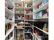 Spacious walk-in pantry with ample shelving for organized storage and a wine refrigerator at 10129 Sw 77Th Loop, Ocala, FL 34481