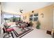 Enclosed patio with ceiling fan and lots of natural light featuring chairs and a table set on a neutral area rug at 10129 Sw 77Th Loop, Ocala, FL 34481