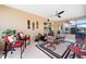 Enclosed patio with ceiling fan and lots of natural light featuring chairs and a table set on a neutral area rug at 10129 Sw 77Th Loop, Ocala, FL 34481