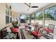 Enclosed patio with ceiling fan and lots of natural light featuring chairs and a table set on a neutral area rug at 10129 Sw 77Th Loop, Ocala, FL 34481