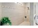 Walk-in shower with tiled walls, a shower head, and a built-in corner shelf at 10129 Sw 77Th Loop, Ocala, FL 34481