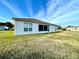 Home's backyard with grassy lawn and screened enclosure at 1033 Sw 159Th St, Ocala, FL 34473