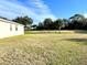 Home's backyard with grassy lawn and screened enclosure at 1033 Sw 159Th St, Ocala, FL 34473