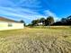 Home's backyard with grassy lawn and screened enclosure at 1033 Sw 159Th St, Ocala, FL 34473