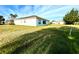 Home's backyard with grassy lawn and screened enclosure at 1033 Sw 159Th St, Ocala, FL 34473