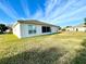 Home's backyard with grassy lawn and screened enclosure at 1033 Sw 159Th St, Ocala, FL 34473