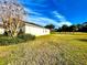 Home's backyard with grassy lawn and screened enclosure at 1033 Sw 159Th St, Ocala, FL 34473