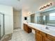 Elegant bathroom featuring double vanity, large mirror, and updated fixtures at 1033 Sw 159Th St, Ocala, FL 34473