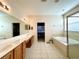 Large bathroom with double vanity, soaking tub, and separate shower at 1033 Sw 159Th St, Ocala, FL 34473