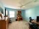 Bright bedroom with light blue walls, ceiling fan, and a home office setup at 1033 Sw 159Th St, Ocala, FL 34473