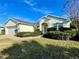 One-story house featuring a two-car garage and lush landscaping at 1033 Sw 159Th St, Ocala, FL 34473