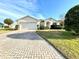One-story house with a two-car garage and landscaped lawn at 1033 Sw 159Th St, Ocala, FL 34473