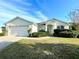 One story house with a two-car garage and well-maintained lawn at 1033 Sw 159Th St, Ocala, FL 34473