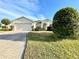 One-story house with a two-car garage and manicured lawn at 1033 Sw 159Th St, Ocala, FL 34473