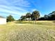 Sunny golf course with palm trees and rolling green fairways at 1033 Sw 159Th St, Ocala, FL 34473