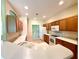Galley kitchen with wood cabinets and white appliances at 1033 Sw 159Th St, Ocala, FL 34473