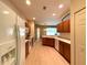Bright kitchen featuring wood cabinets, an island, and light-colored flooring at 1033 Sw 159Th St, Ocala, FL 34473