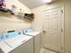 Laundry room with washer, dryer, and storage shelves at 1033 Sw 159Th St, Ocala, FL 34473