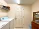 Laundry room with washer, dryer, and storage shelves at 1033 Sw 159Th St, Ocala, FL 34473