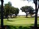 Picturesque golf course view with mature trees at 10922 Se 168Th Loop, Summerfield, FL 34491