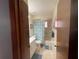 Clean bathroom with tub, shower, vanity, and updated flooring at 10949 Sw 79Th Ter, Ocala, FL 34476