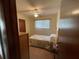 Simple bedroom with a twin bed, wood furniture, and ceiling fan at 10949 Sw 79Th Ter, Ocala, FL 34476