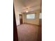 A cozy bedroom with pink carpet, a ceiling fan, and a closet for comfortable living at 10949 Sw 79Th Ter, Ocala, FL 34476